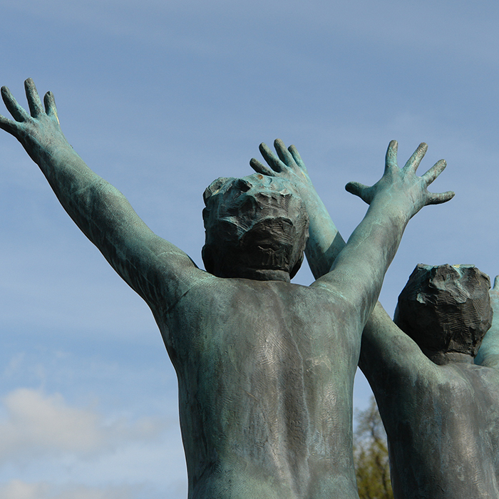 Statue of two boys with arms outstretched