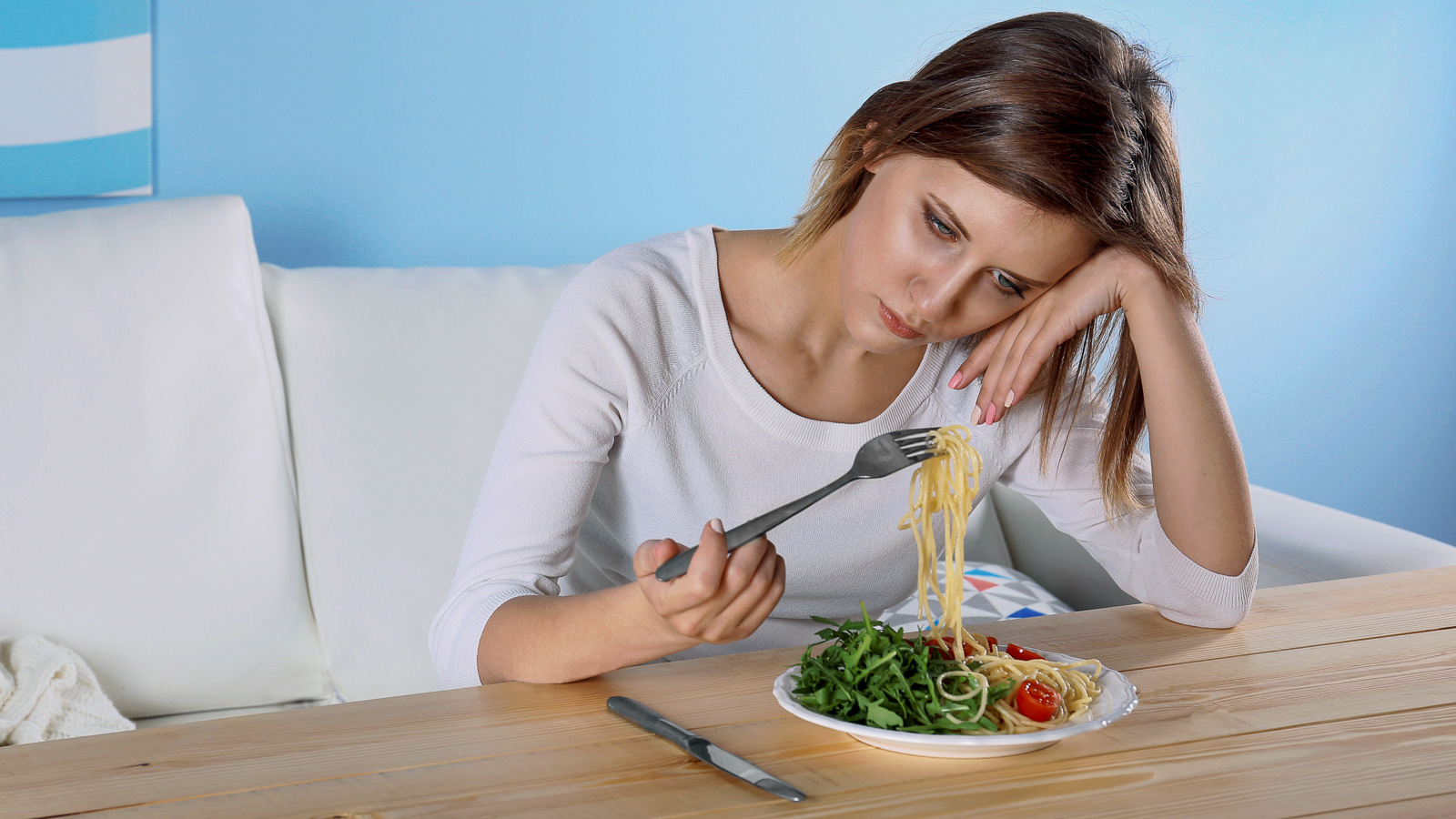 Trist jente spiser spaghetti
