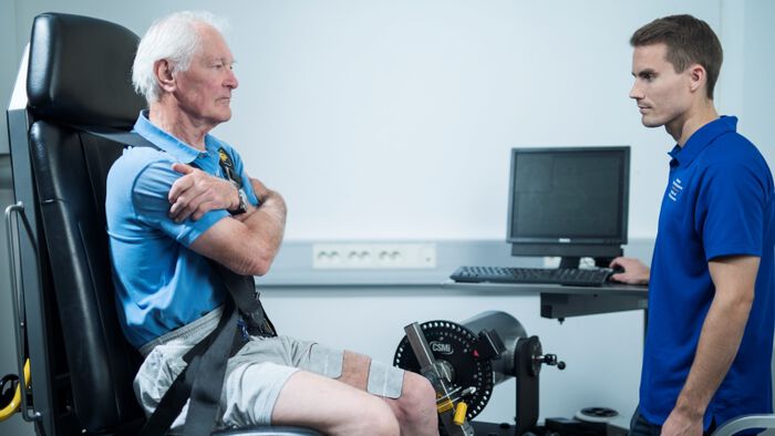 Elderly man test muscle strenght in laboratory